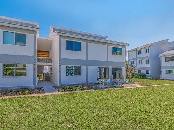 a house view with swimming pool in front of it
