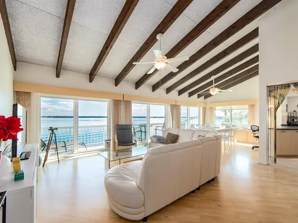 a living room with furniture and a floor to ceiling window