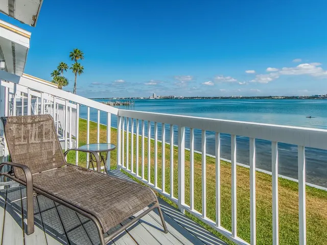 a view of a balcony with lake view and a potted plant