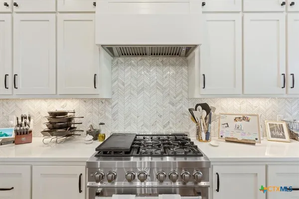 a kitchen with a stove and cabinets