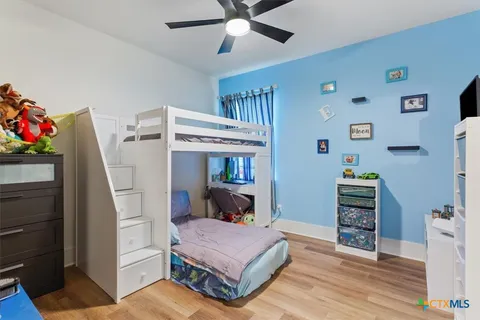 a bedroom with furniture and a baby crib