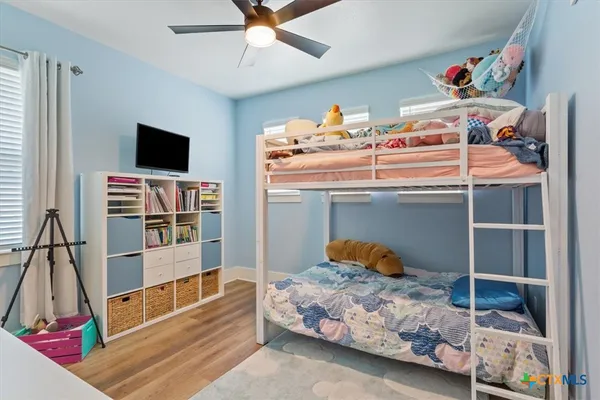 a bedroom with a bed and a flat tv screen
