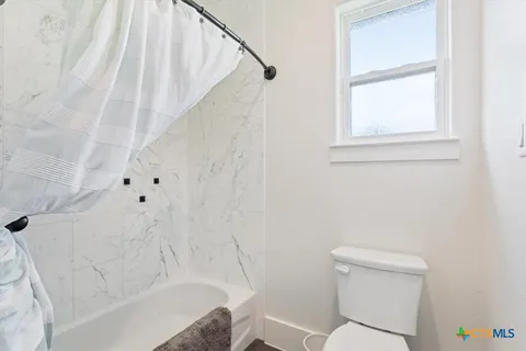a bathroom with a toilet and a bathtub
