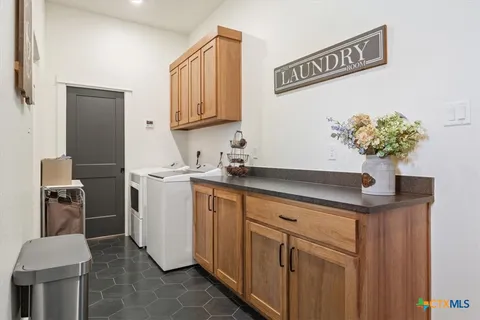a kitchen with stainless steel appliances granite countertop a sink and a refrigerator