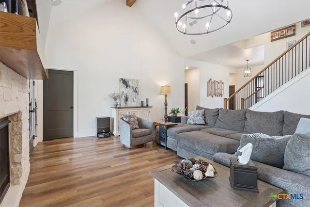 a living room with furniture kitchen view and a fireplace