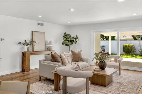 a living room with furniture and a potted plant