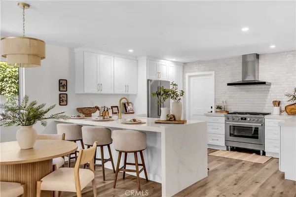 a kitchen with white cabinets and appliances