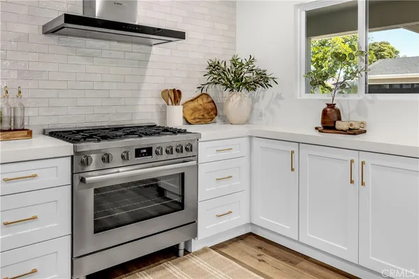a kitchen with a stove and cabinets