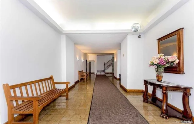 a view of a hallway with furniture and a potted plant