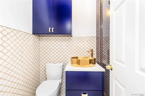 a bathroom with a sink a toilet and a mirror
