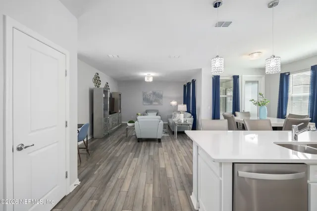 a kitchen with granite countertop a sink stove and cabinets