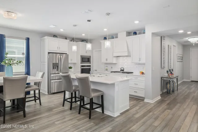 a living room with furniture a chandelier and a large window