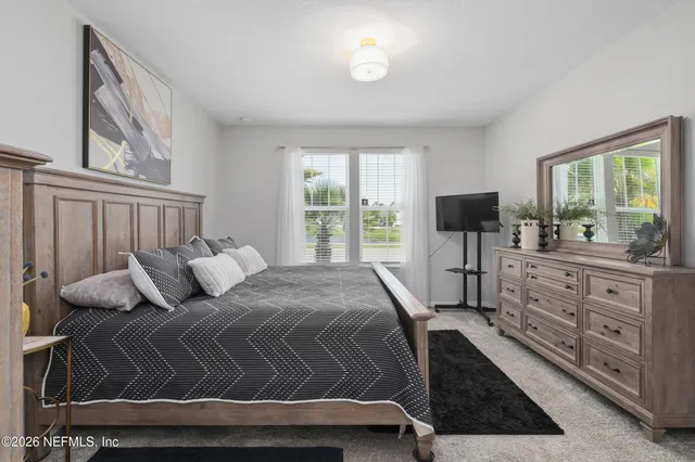 a bathroom with a sink a potted plant and a mirror