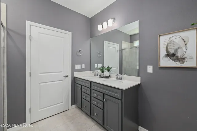 a bedroom with two beds and painting on the wall