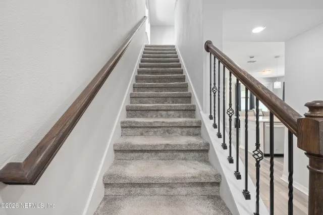a room with a window and a kitchen space