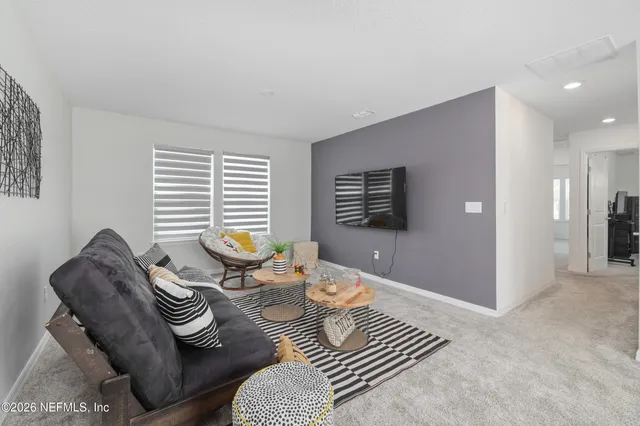 a living room with furniture and a potted plant