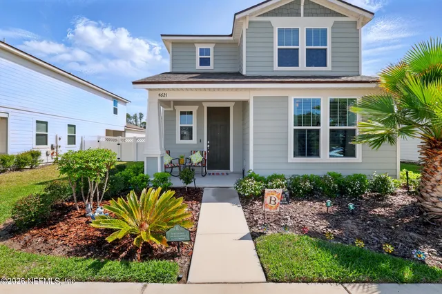 a front view of a house with garden and porch