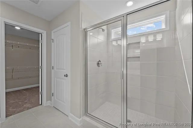 a bathroom with a glass shower door