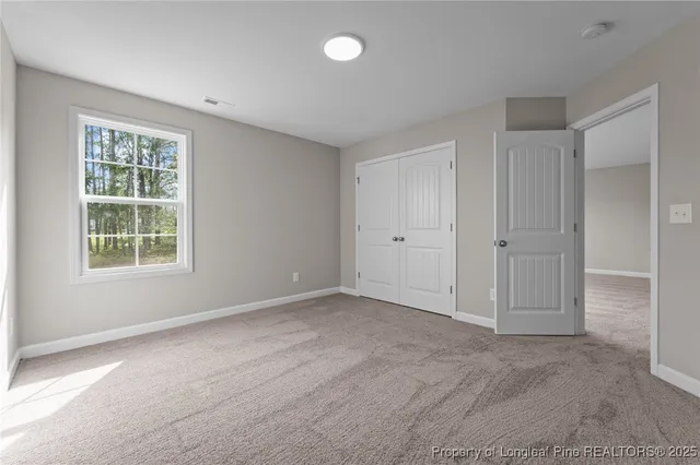 an empty room with windows and closet
