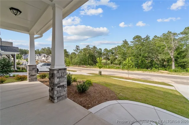 a view of swimming pool with outdoor seating and plants