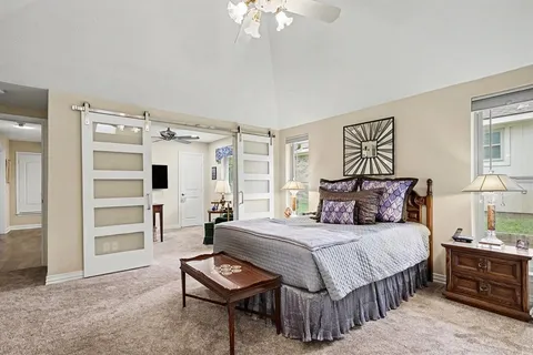 a bedroom with a bed and a chandelier