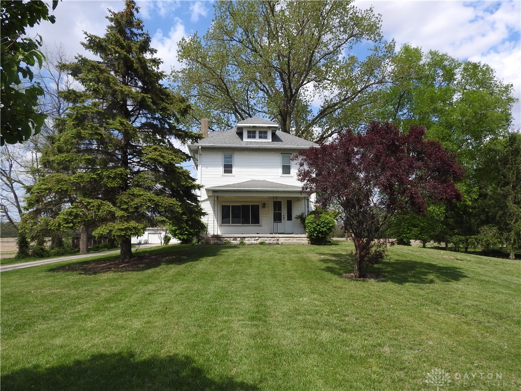 2105 East Loy Road Piqua, OH 45356 - Photo 1 of 26 This classic white farmhouse sits on a lush green lawn, surrounded by mature trees.