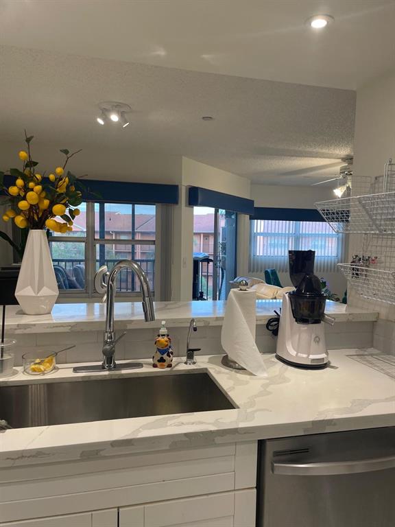 a kitchen with a sink and cabinet
