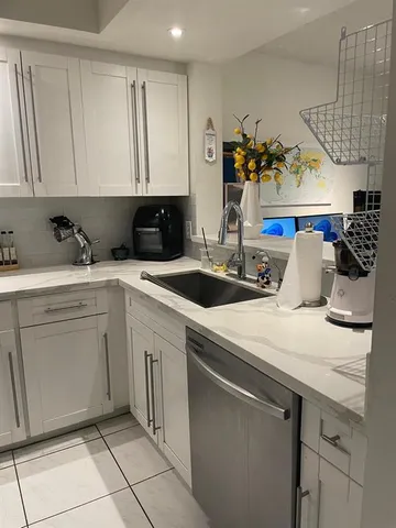 a kitchen with stainless steel appliances a refrigerator sink and microwave