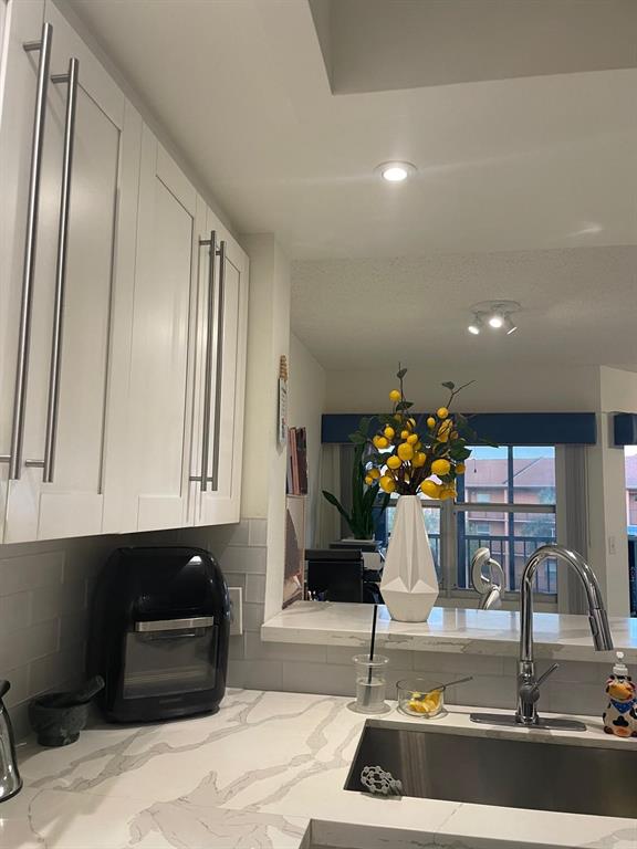 701 Southwest 142nd Avenue, Unit 411S Pembroke Pines, FL 33027 - Photo 4 of 9 a room with table and chair