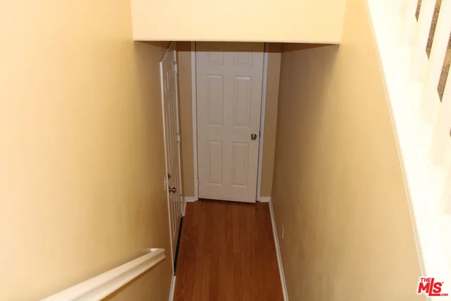 a kitchen with granite countertop a refrigerator and a stove top oven