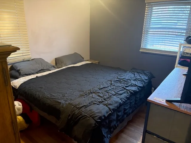 a bed sitting in a bedroom next to a window