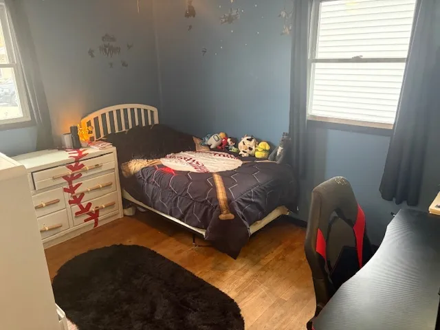 a bedroom with a bed and a window