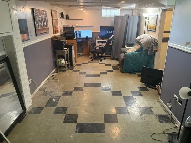 a view of a hallway with workspace and mirrors