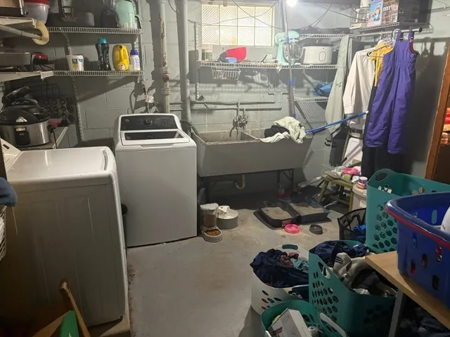 a utility room with dryer washer and other items