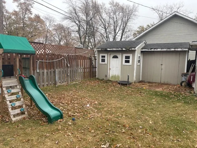 a backyard of a house with barbeque oven