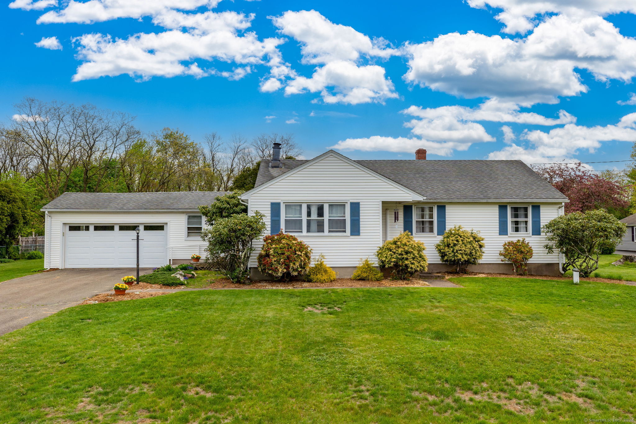 21 Norton Road East Windsor, CT 06016 - Photo 1 of 1 a front view of a house with a garden and trees