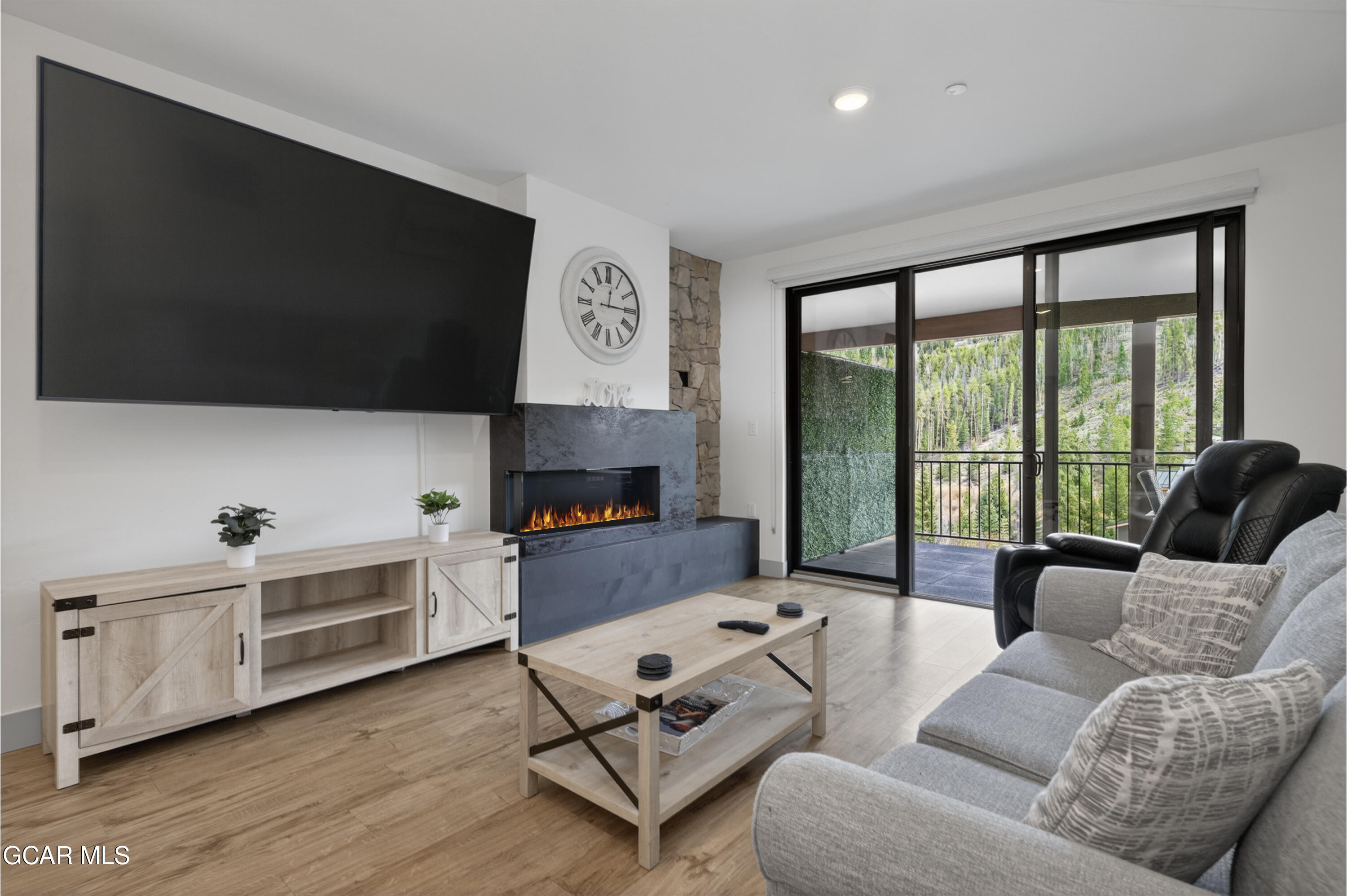 144 Ski Idlewild Road, Unit 2404 Winter Park, CO 80482 - Photo 12 of 43 a living room with furniture and a flat screen tv