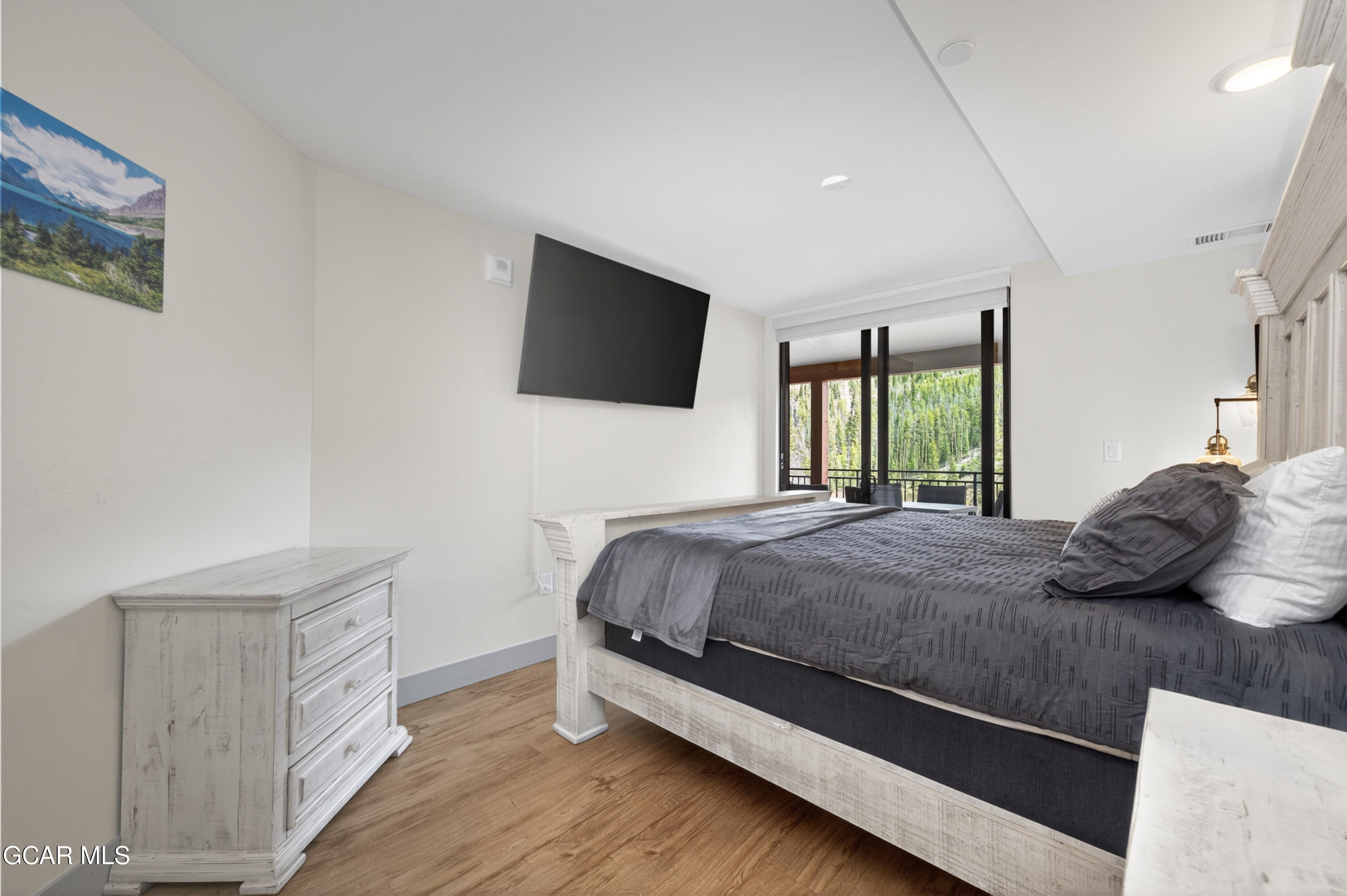 144 Ski Idlewild Road, Unit 2404 Winter Park, CO 80482 - Photo 17 of 43 a bedroom with a bed and a flat screen tv