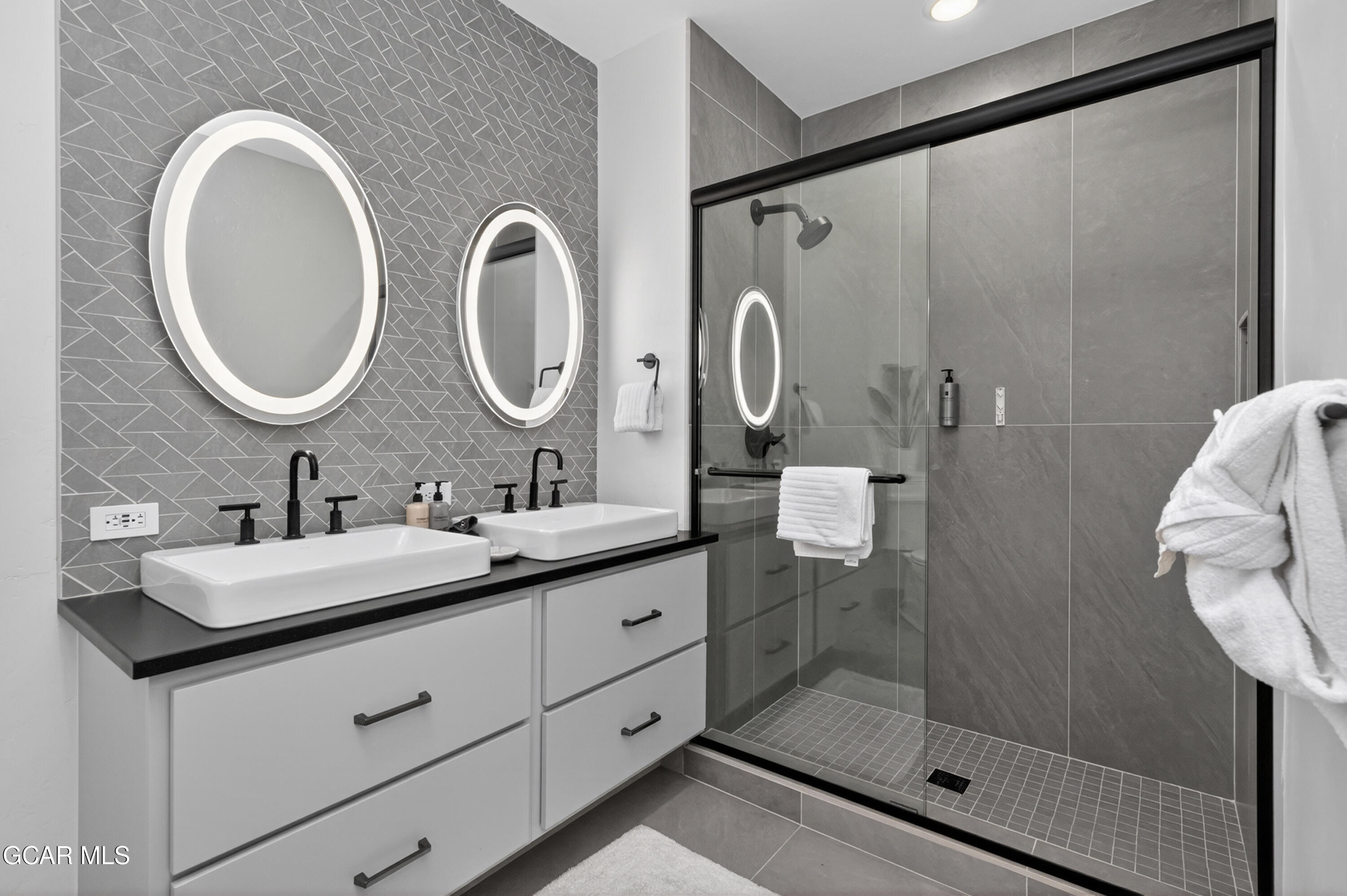 144 Ski Idlewild Road, Unit 2404 Winter Park, CO 80482 - Photo 19 of 43 a bathroom with a double vanity sink mirror and shower