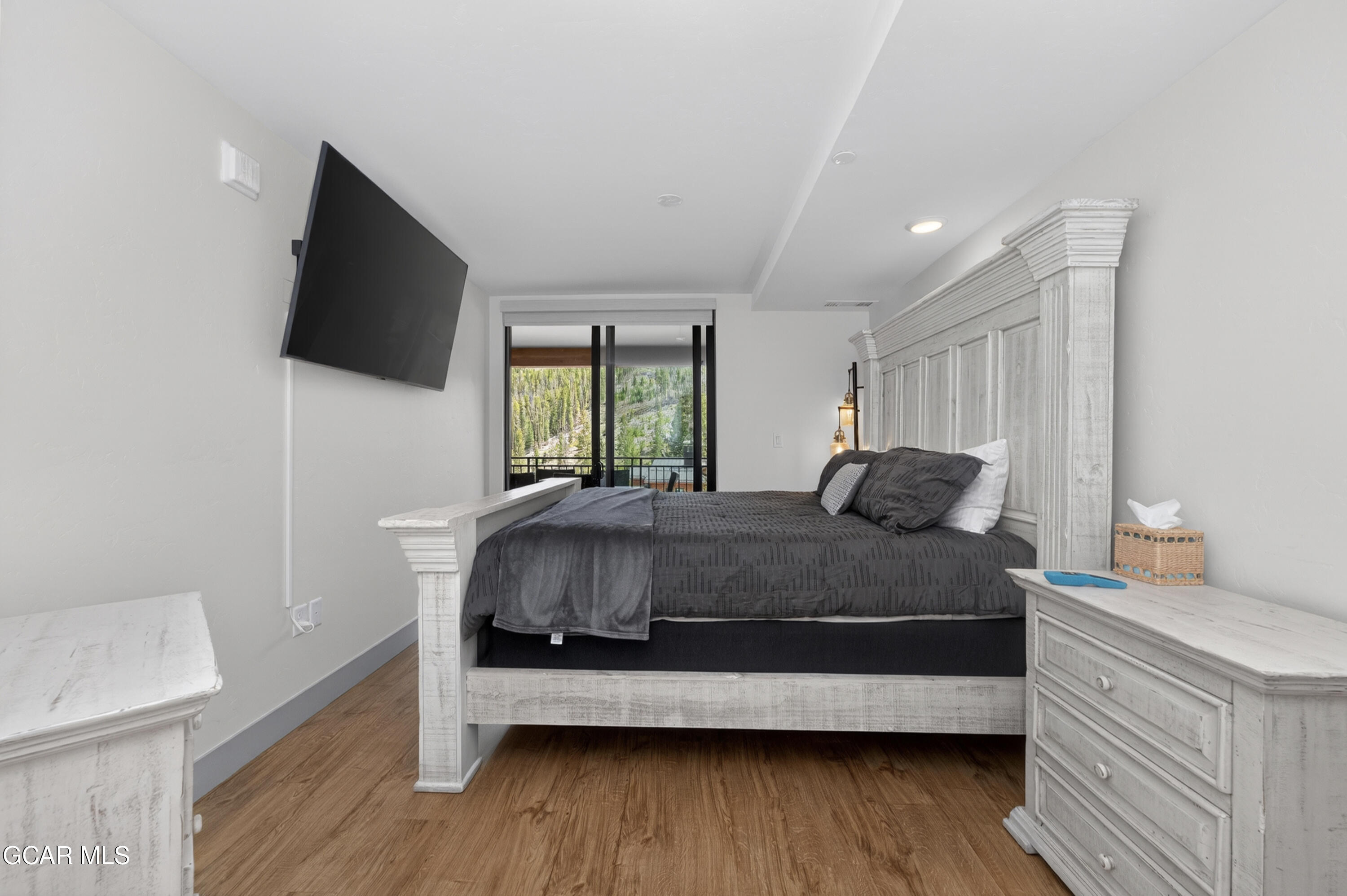 144 Ski Idlewild Road, Unit 2404 Winter Park, CO 80482 - Photo 20 of 43 a bedroom with a bed and a flat screen tv