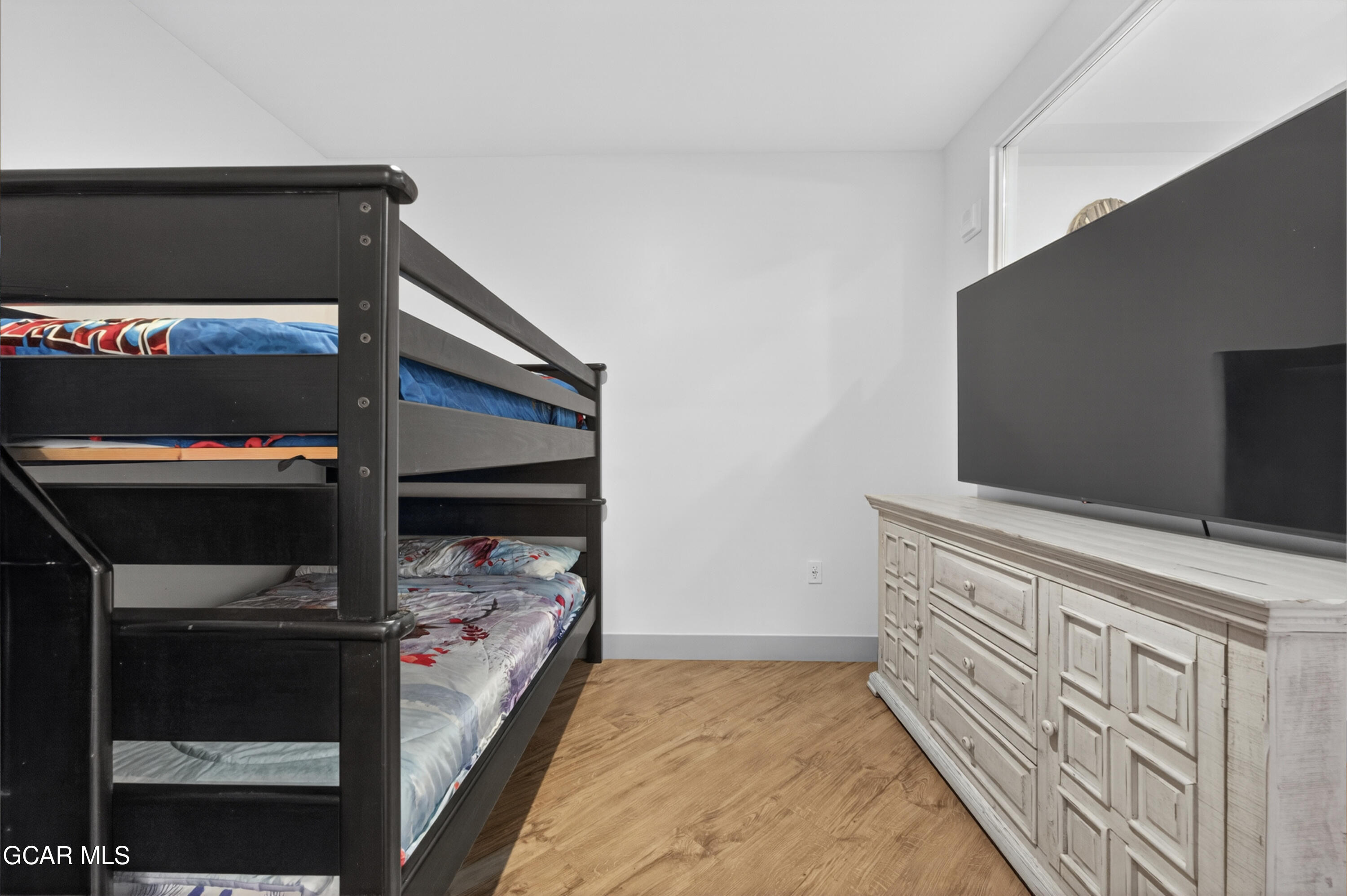 144 Ski Idlewild Road, Unit 2404 Winter Park, CO 80482 - Photo 25 of 43 a kitchen with white cabinets and a wooden floor