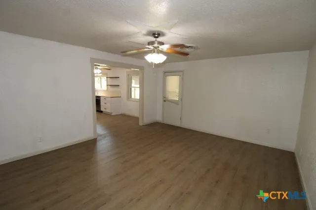wooden floor in an empty room with a window