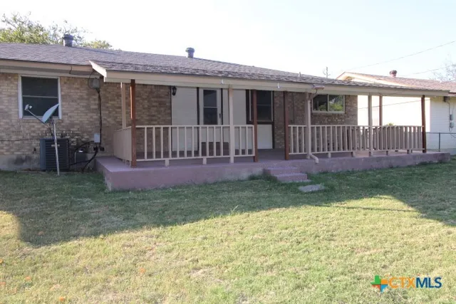 a view of a house with a yard and deck