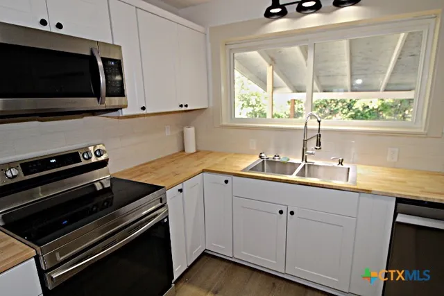 a kitchen with a sink and a window