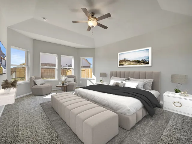 a spacious bedroom with a bed and window