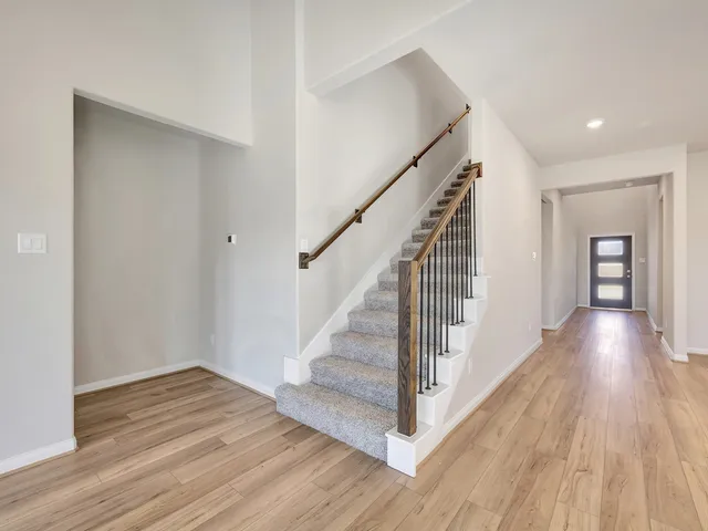 a view of a hallway view with wooden floor and staircase