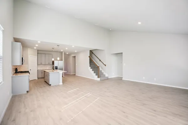 a living room with furniture potted plant and a large window