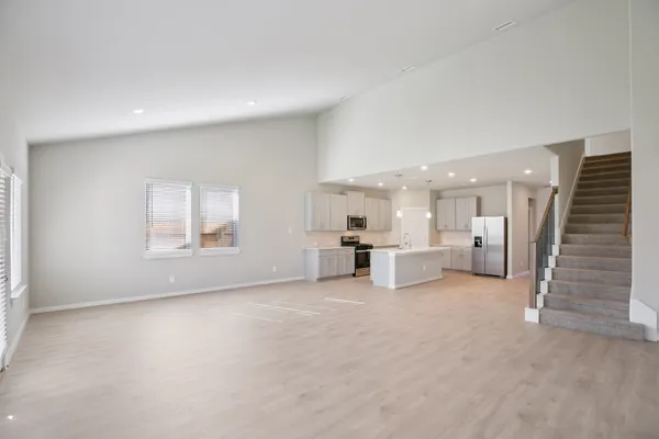 a kitchen with refrigerator a sink and cabinets