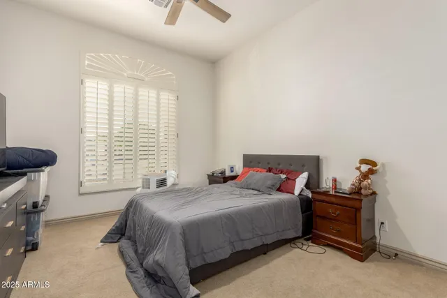 a bedroom with a bed and a dresser