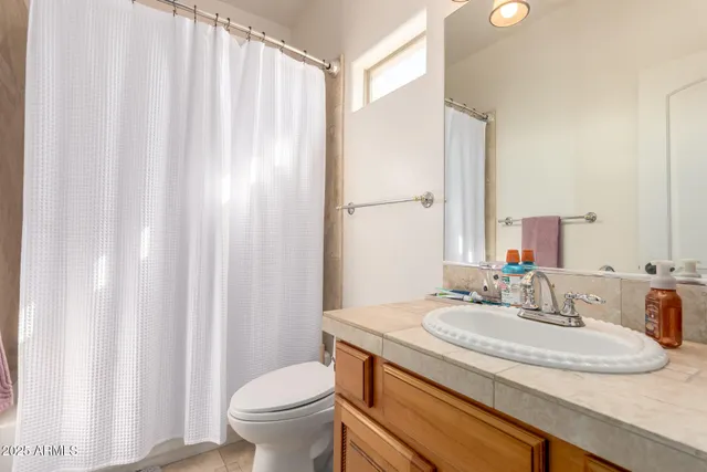 a view of a patio with table and chairs and floor to ceiling window